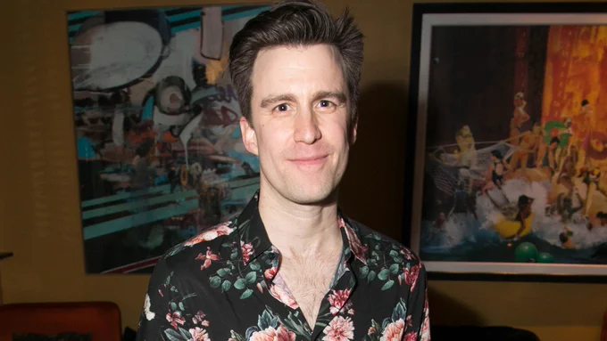 A photo showing a man smiling into the camera 