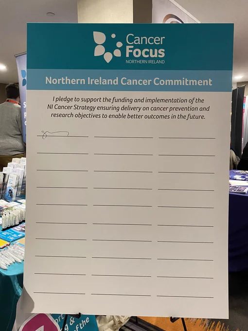 Cancer Focus NI Cancer Commitment pledge board with one signature