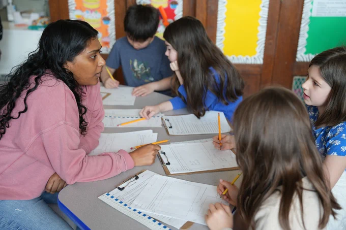 NYC Public Schools teacher with students in class.