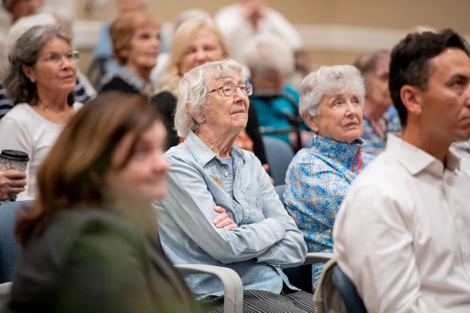 Residents at the Village at Penn State listening to Joel Leja speak