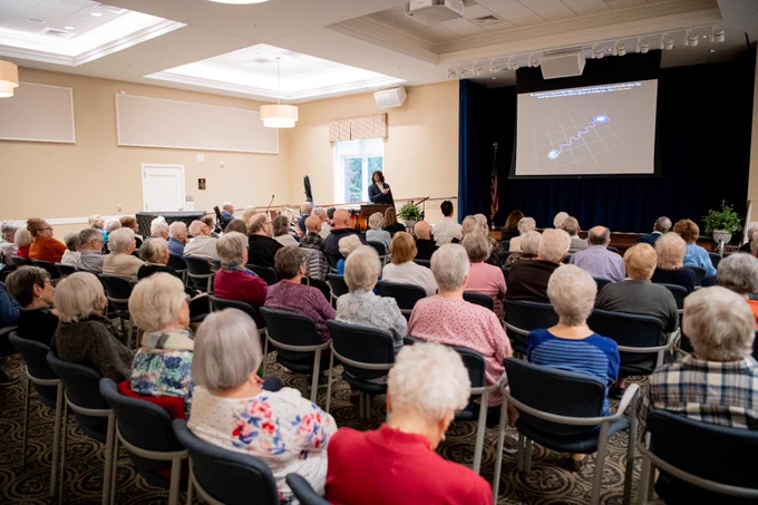 Large crowed of residents from the Village at Penn State listening to Joel Leja present 