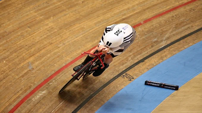 A cyclist on an indoor track