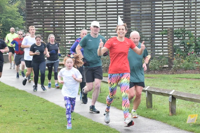 Image of group of parkrunners with one parkrunner wearing a party hat