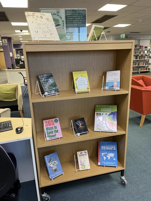 A display of 10 books from across the Library's collection, covers facing out, over 4 shelves on the theme of Green Libraries Week.