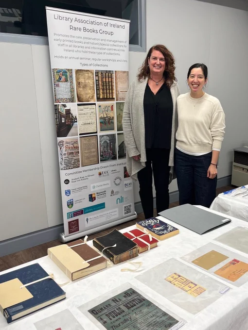 Two women, the presenters named in the tweet, standing beside the LAI Rare Books Group pop-up banner.