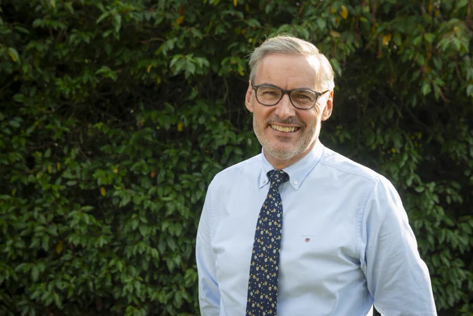 Photo of UK Scouts new CEO, Aidan Jones,  in a light blue shirt and patterned tie.