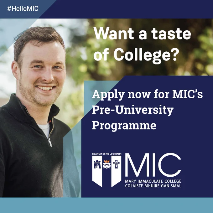 A male MIC student standing outside on a sunny day. He is smiling and wearing a black zip neck knit jumper and a white t-shirt. He has short brown hair and a brown beard. The text on the image is 'Want a taste of College? Apply now for MIC's Pre-University Programme. #HelloMIC'