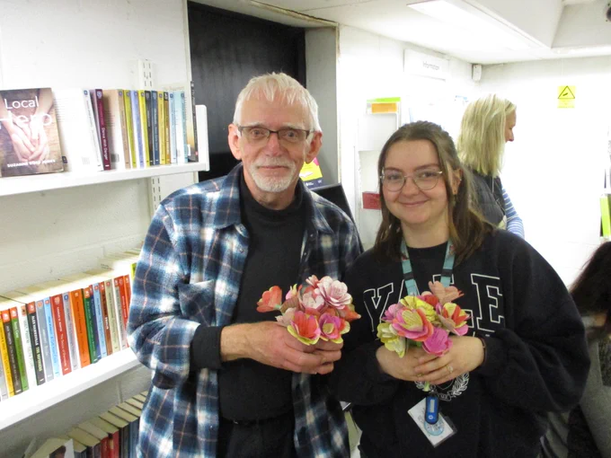 two people with paper bouqets