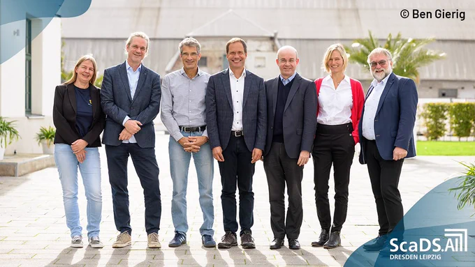 Prof. Hilde Kühne (Tübingen AI Center), Prof. Christian Bauckhage (Lamarr Institute),  Prof. Antonio Krüger (DFKI), Dr Jack Thoms (BIFOLD),  Prof. Thomas Seidl (MCML), Prof. Birte Platow (ScaDS.AI Dresden/Leipzig) und Prof. Wolfgang E. Nagel (ScaDS.AI Dresden/Leipzig) (from left to right)