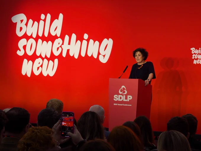 Claire Hanna MP speaking at podium at SDLP Conference
