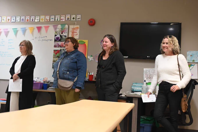 Staff listening to information about Big Brothers Big Sisters.