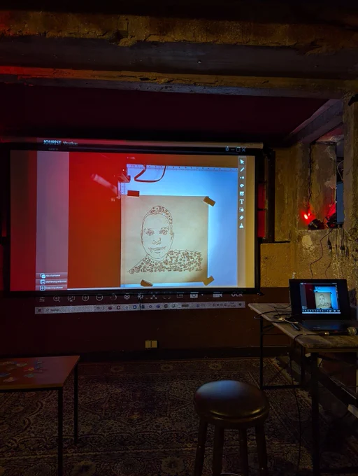 Projector shows a webcam feed for a pen plot. The plot is an abstract portrait of bleeptrack 