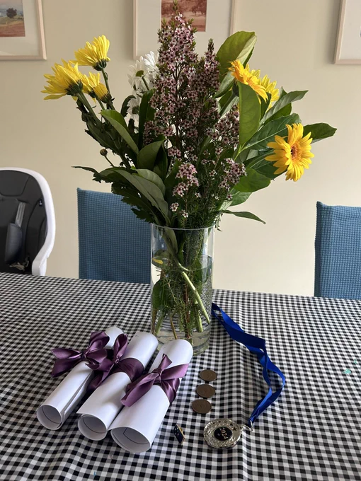 Flowers and awards at a kitchen table