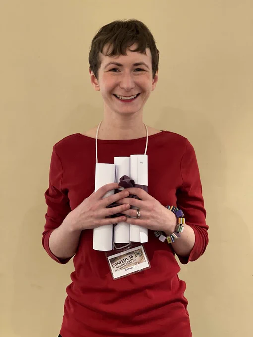 A woman holding certificates