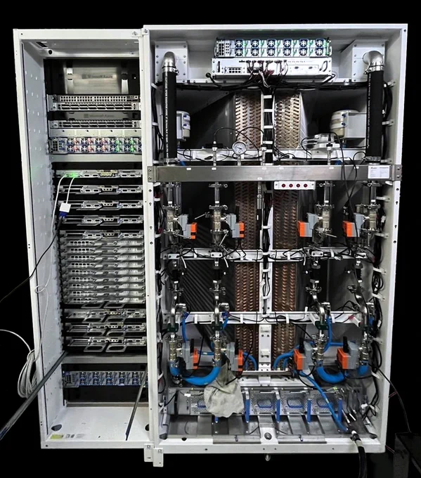 An image of an open server rack showcasing an intricate setup of hardware components, including multiple server units, cables, cooling systems, and various technical equipment.