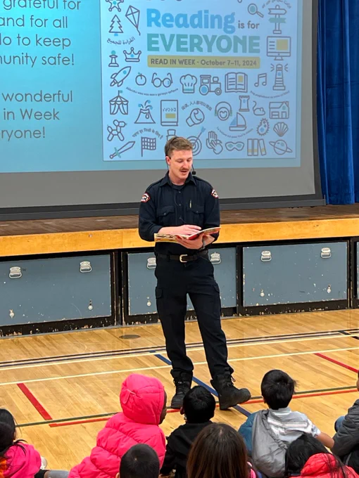 A firefighter reads to students during Read In Week.