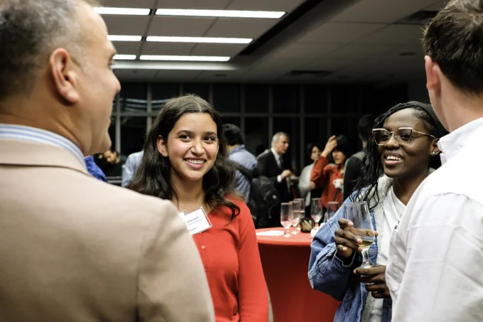Attendees engaging in conversation at a networking event.