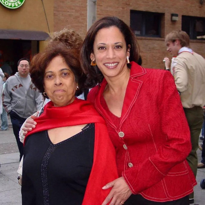 Vice President Kamala Harris, wearing red, standing next to her mother.