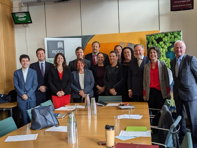 This picture shows Alice Macdonald MP standing with several members of the Environment APPG in an office space.