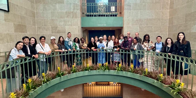 Group of people smiling and posing inside the National Museum of African Art.