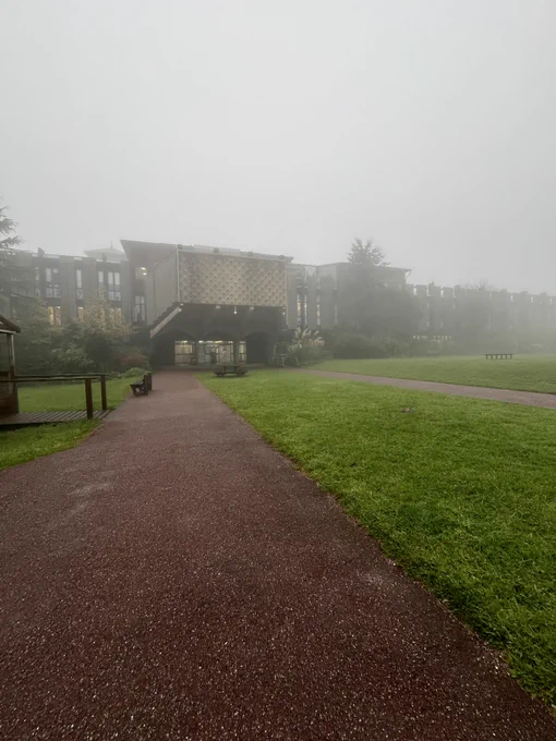 Plymouth Marjon University Library, as seen from the University Octagon, on a grey and misty day.