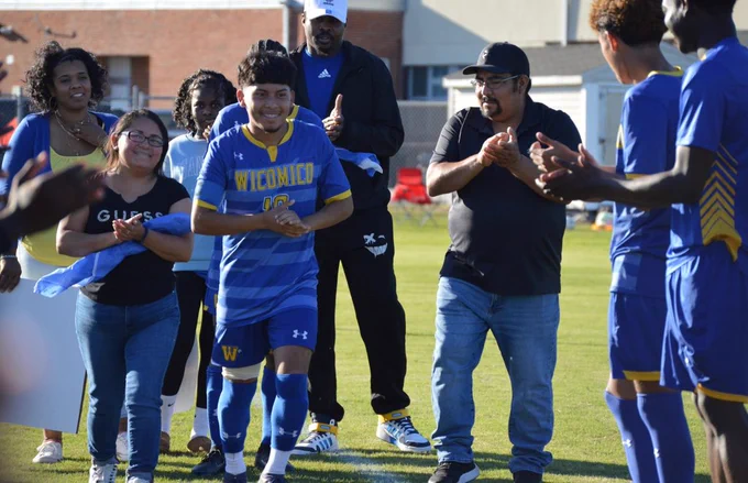 Image of Wi-Hi senior boys soccer player being celebrated by teammates and family