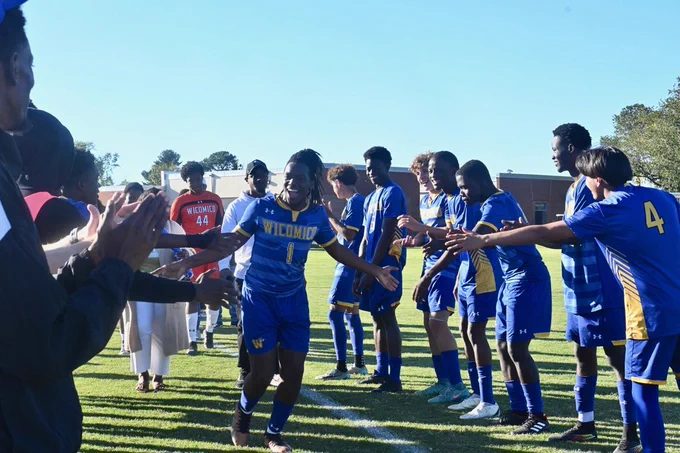 Image of Wi-Hi senior boys soccer player being celebrated by teammates 