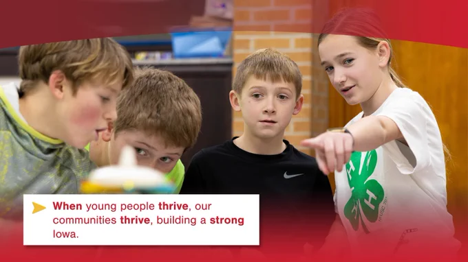 Four children engaged in an activity at a table with a 4-H logo visible, promoting community development in Iowa.