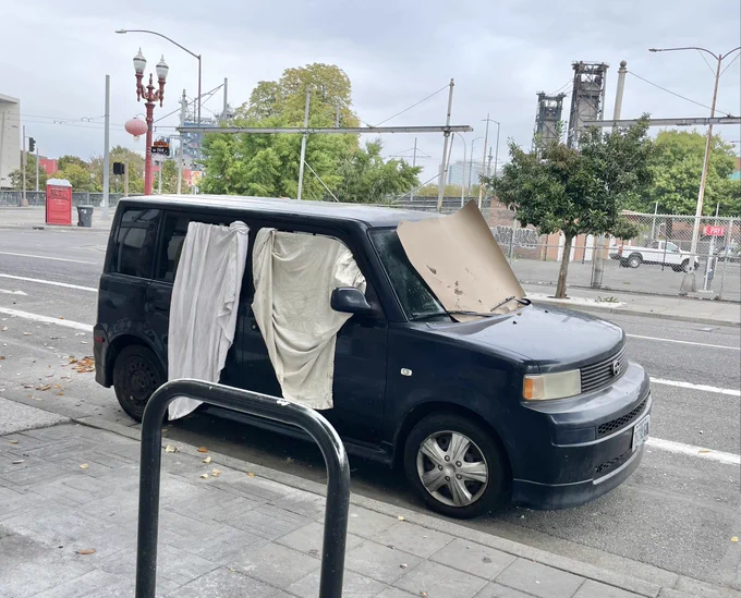 Car with sheets covering its windows