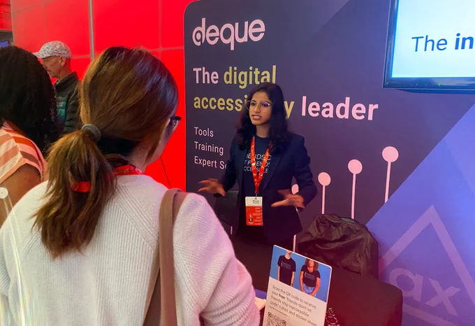 Divya from Deque chatting with attendees at the Deque booth