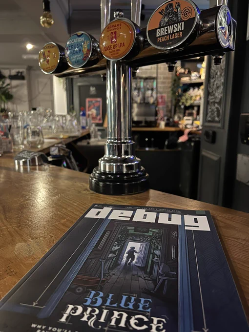 Issue 6 of Debug at the bar in a pub called Barcadia