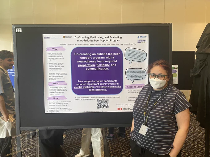 Woman standing in front of poster