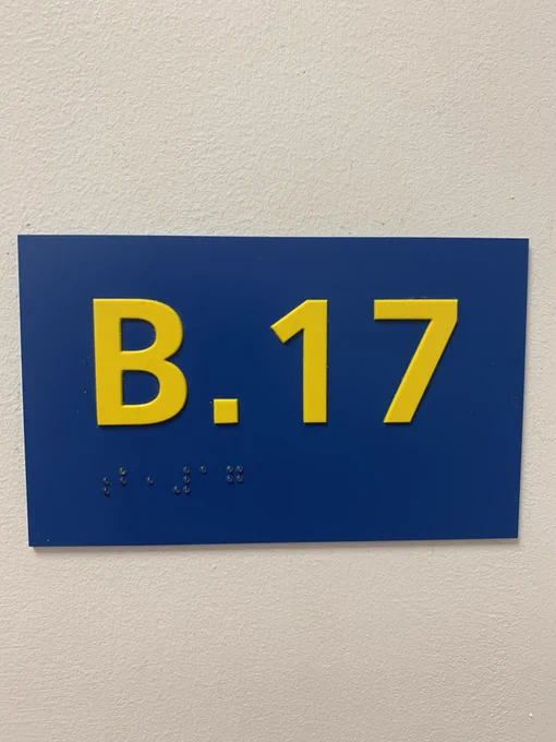 Loving the bold yellow signs everywhere, on a dark blue background with braille at the bottom.