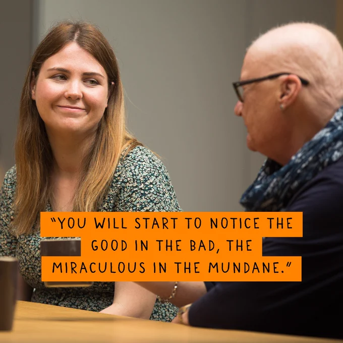 Two women in conversation at a table, one is holding a mug. The quote on the image says 'You will start to notice the good in the bad, the miraculous in the mundane'.