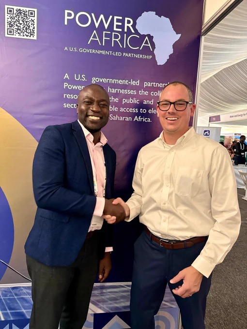 Two men shaking hands at the Power Africa booth.