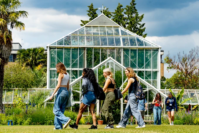 A group of young people cross the main lawn 