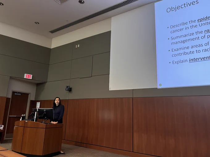 A person stands behind a lectern