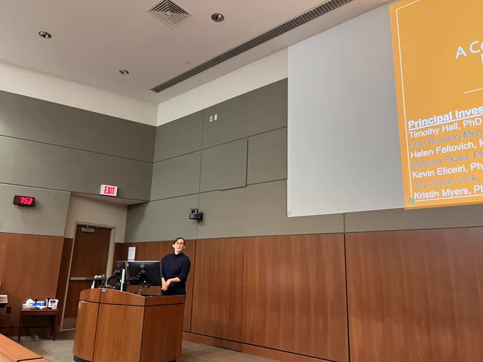 A person stands behind a lectern