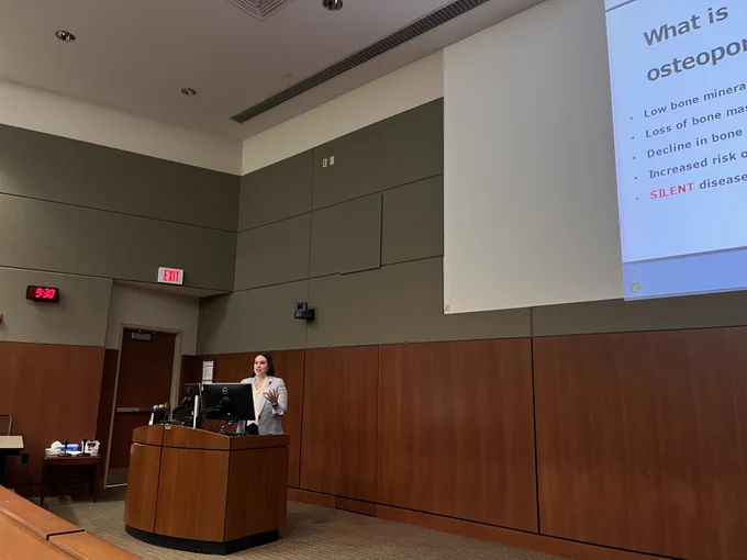 A person stands behind a lectern