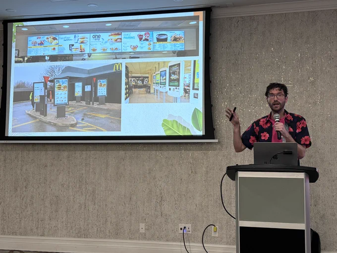 Man presenting in front of a screen