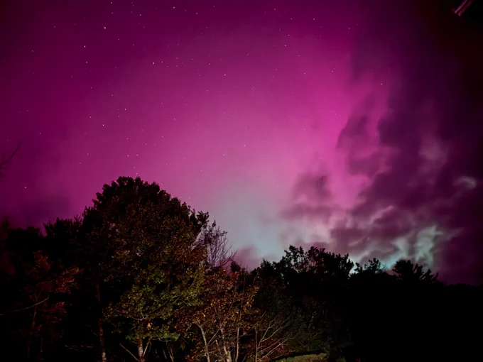 Pink and purple northern lights in sky