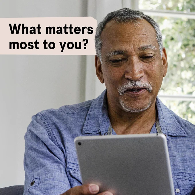 Person using a tablet with the text "What matters most to you?" displayed above.