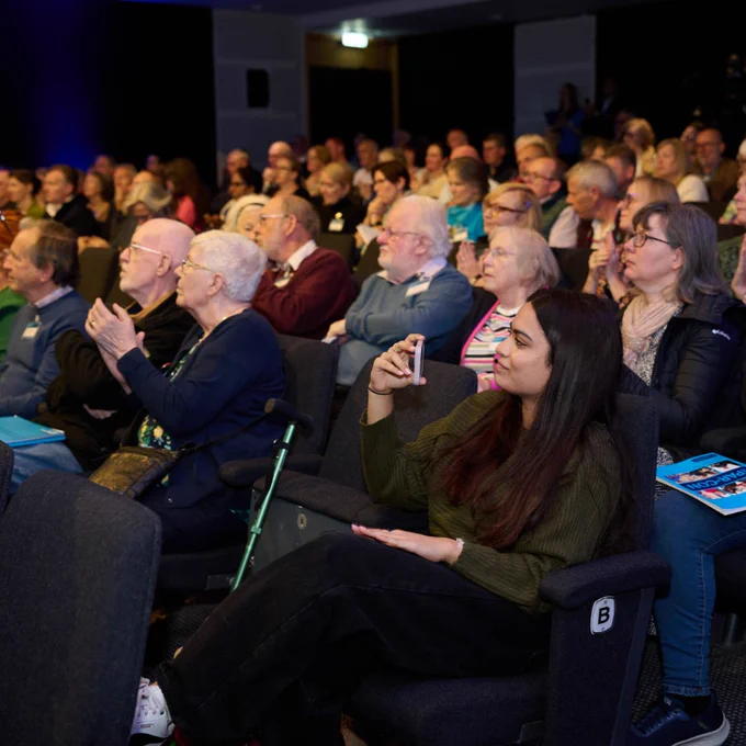 Audience members attentively watching a presentation at ParCon 2024
