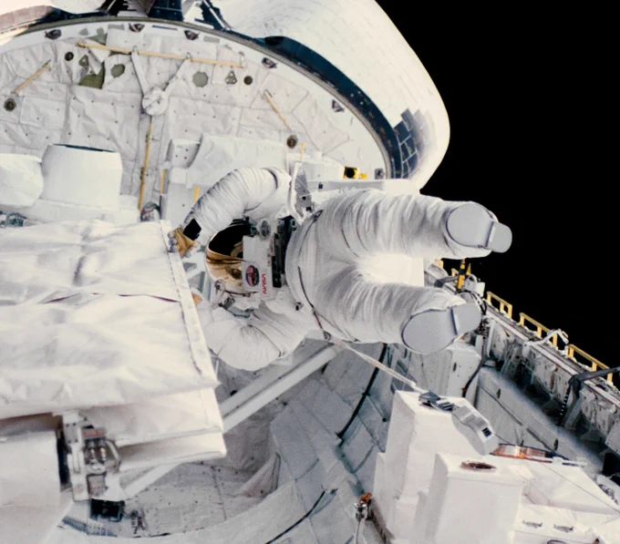 View of Dr. Kathryn D. Sullivan performing an EVA in the payload bay of Space Shuttle Challenger on the STS-41G mission.