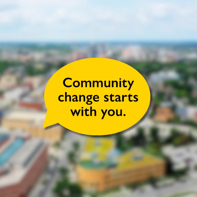 Blurred aerial view of Waterloo with text on top reading community change starts with you inside a speech bubble.