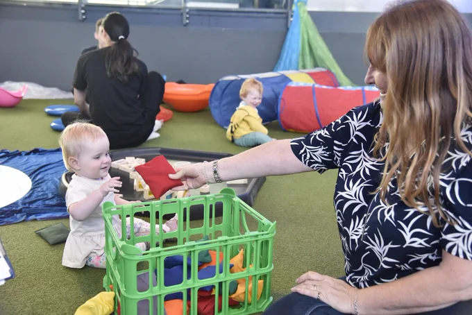 A photo of a mother and a baby playing with toys in the museum's Pitch Gallery.