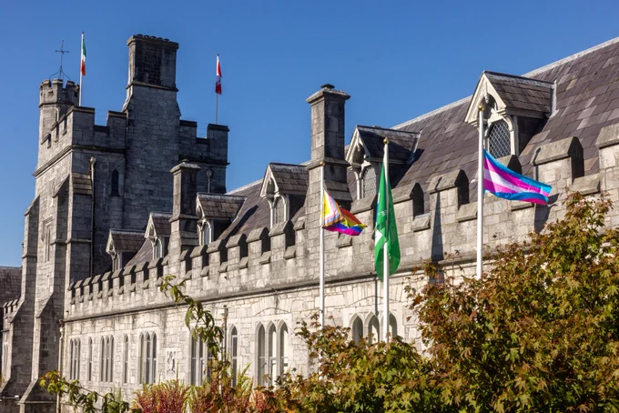 The LGBT Pride flag and the Trans Pride flags on the North Wing ground level flagpoles at UCC's Quad. 
