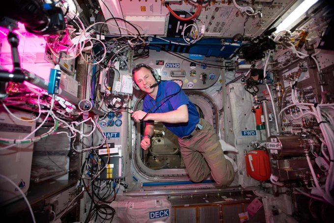 iss059e085130 (May 30, 2019) --- NASA astronaut Nick Hague floats inside Europe's Columbus laboratory module during a HAM radio session using the International Space Station's call sign NA1SS.