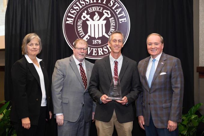 Honoring Mississippi State’s 2024 Ralph E. Powe Research Excellence Award winner Peter Allen, holding the award, are, from left, Vice President for Research and Economic Development Julie Jordan, Vice President for the Division of Agriculture, Forestry and Veterinary Medicine Keith Coble, and MSU President Mark E. Keenum. Allen is a professor in MSU’s Department of Wildlife, Fisheries and Aquaculture who is an internationally recognized researcher in fish physiological ecology. (Photo by Jonah Holland)