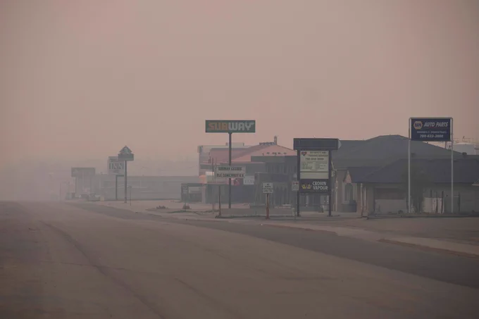 A view of evacuated Fox Creek under a haze of smoke